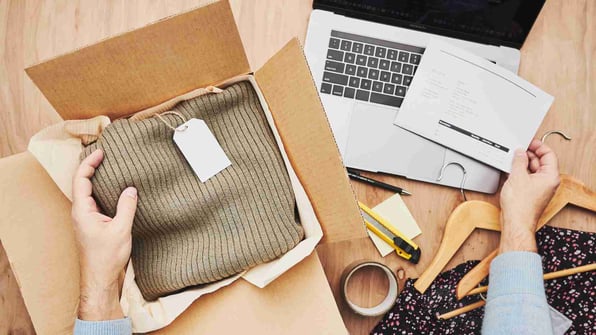 ecommerce store owner packing order for delivery