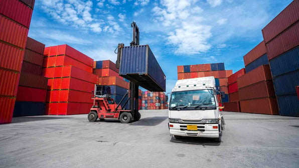 Loading a shipping container on a trailer