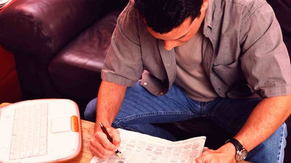 Man reading classified ads in newspaper.jpg