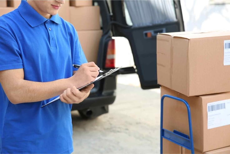 Delivery man with clipboard and packages for delivery