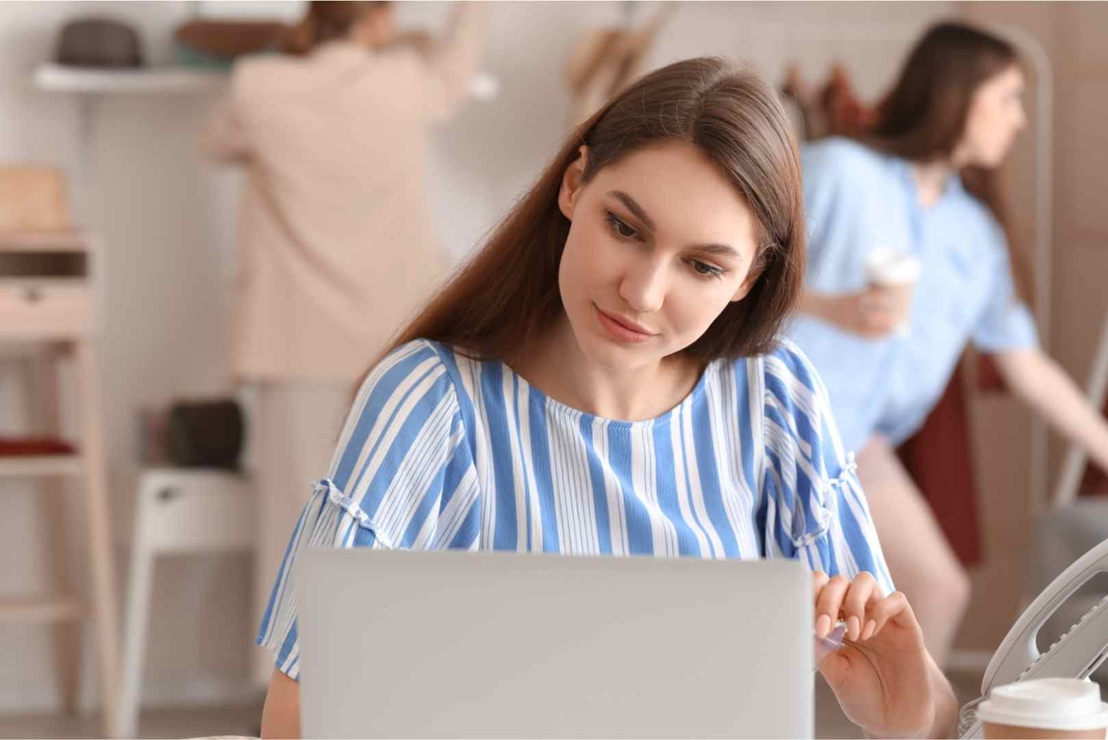 Female business owner processing order in shop