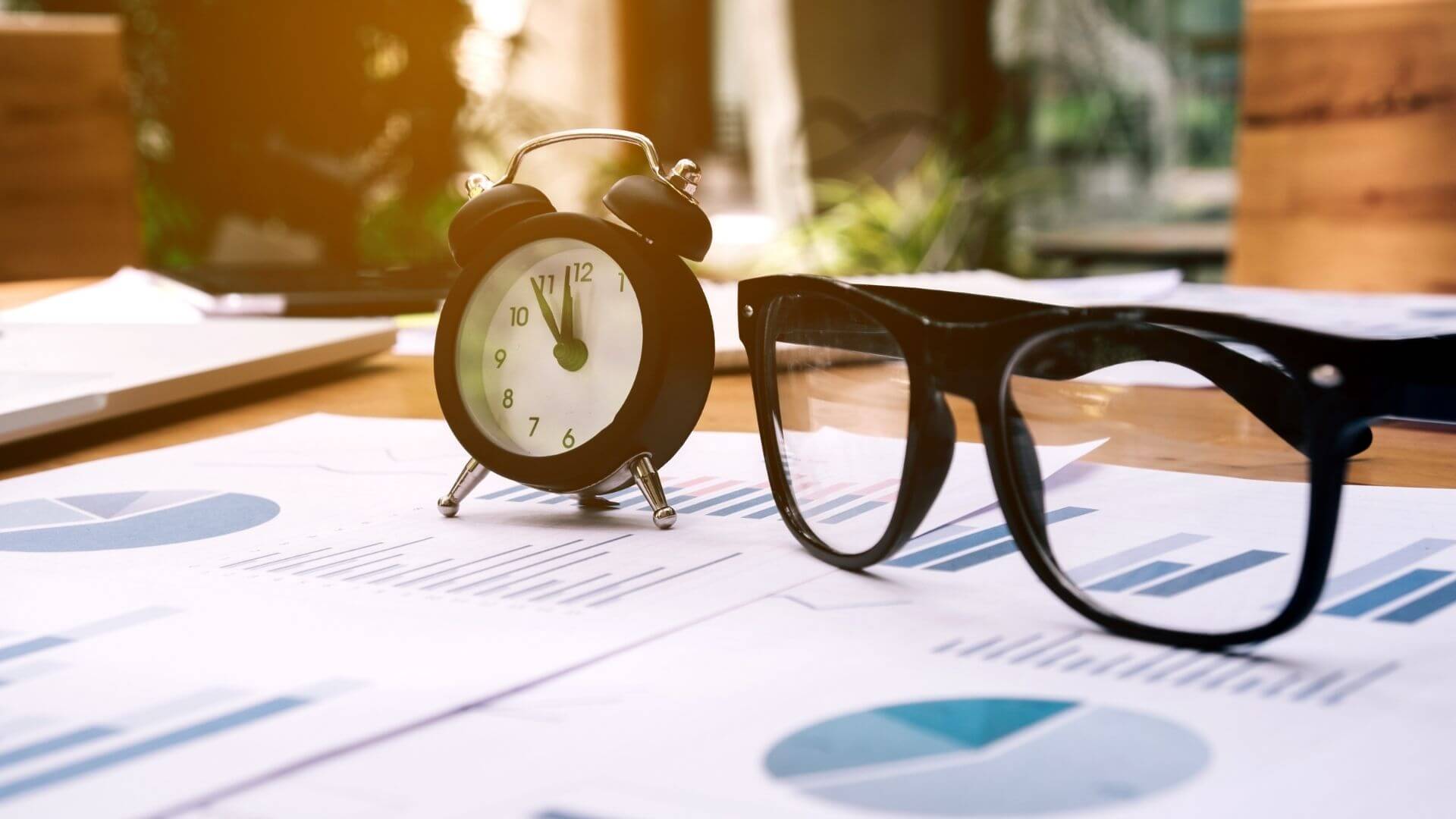 glasses and clock on the business paper