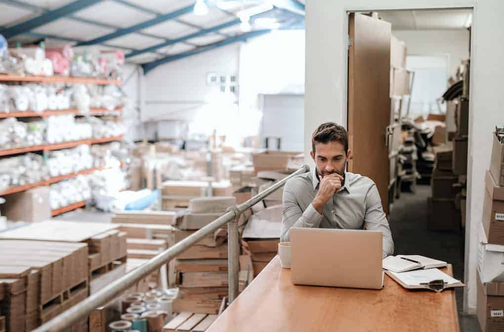 man looking at inventory tracking system on computer