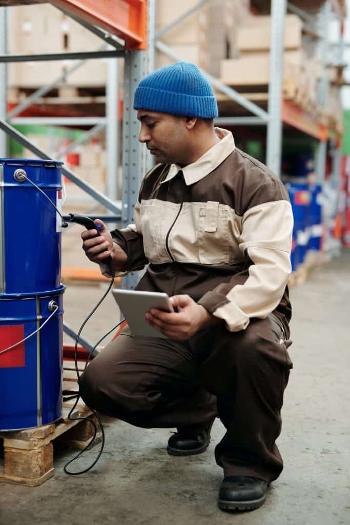 warehouse management worker using barcode scanner.