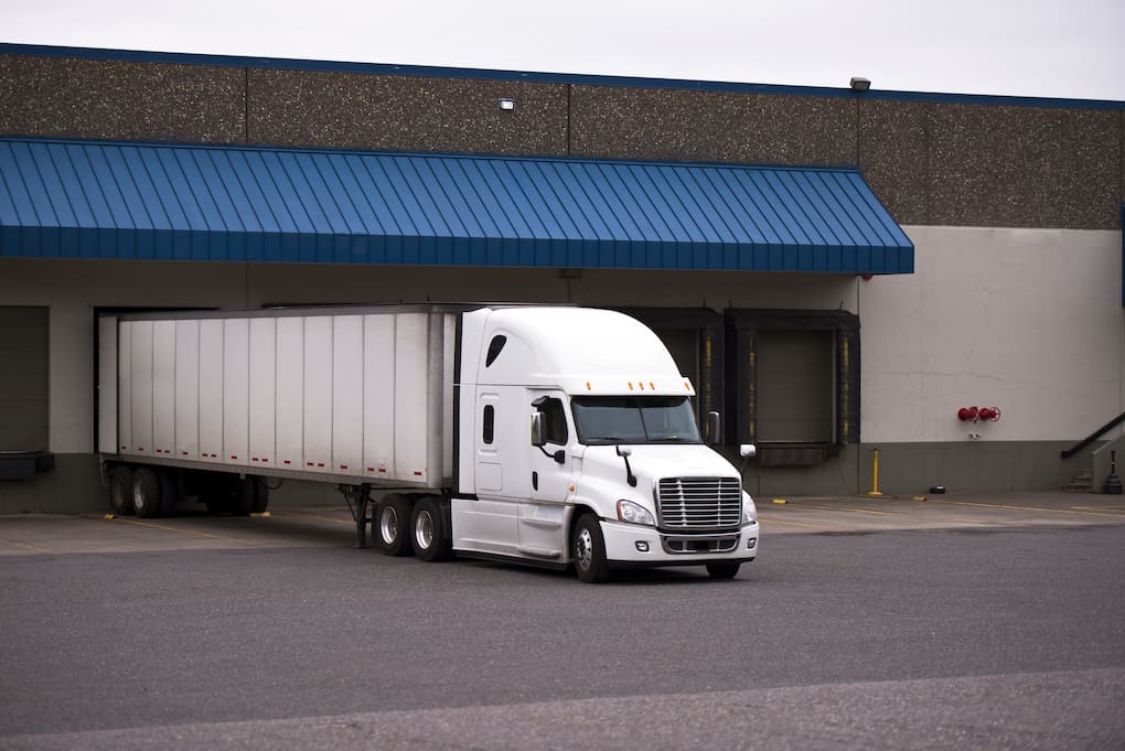 white truck bringing in inventory into warehouse with cross dock