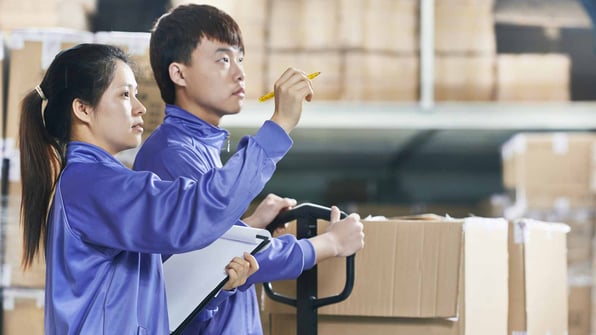 Two Chinese Workers in Warehouse