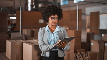 Warehouse manager checking inventory list