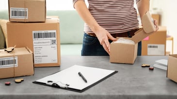 woman preparing parcels for shipment