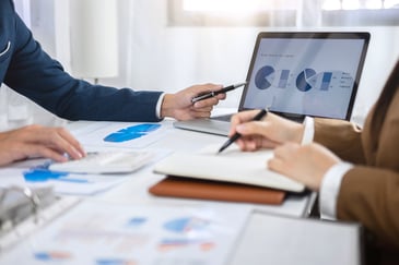 data-collection-report-on-laptop-in-meeting