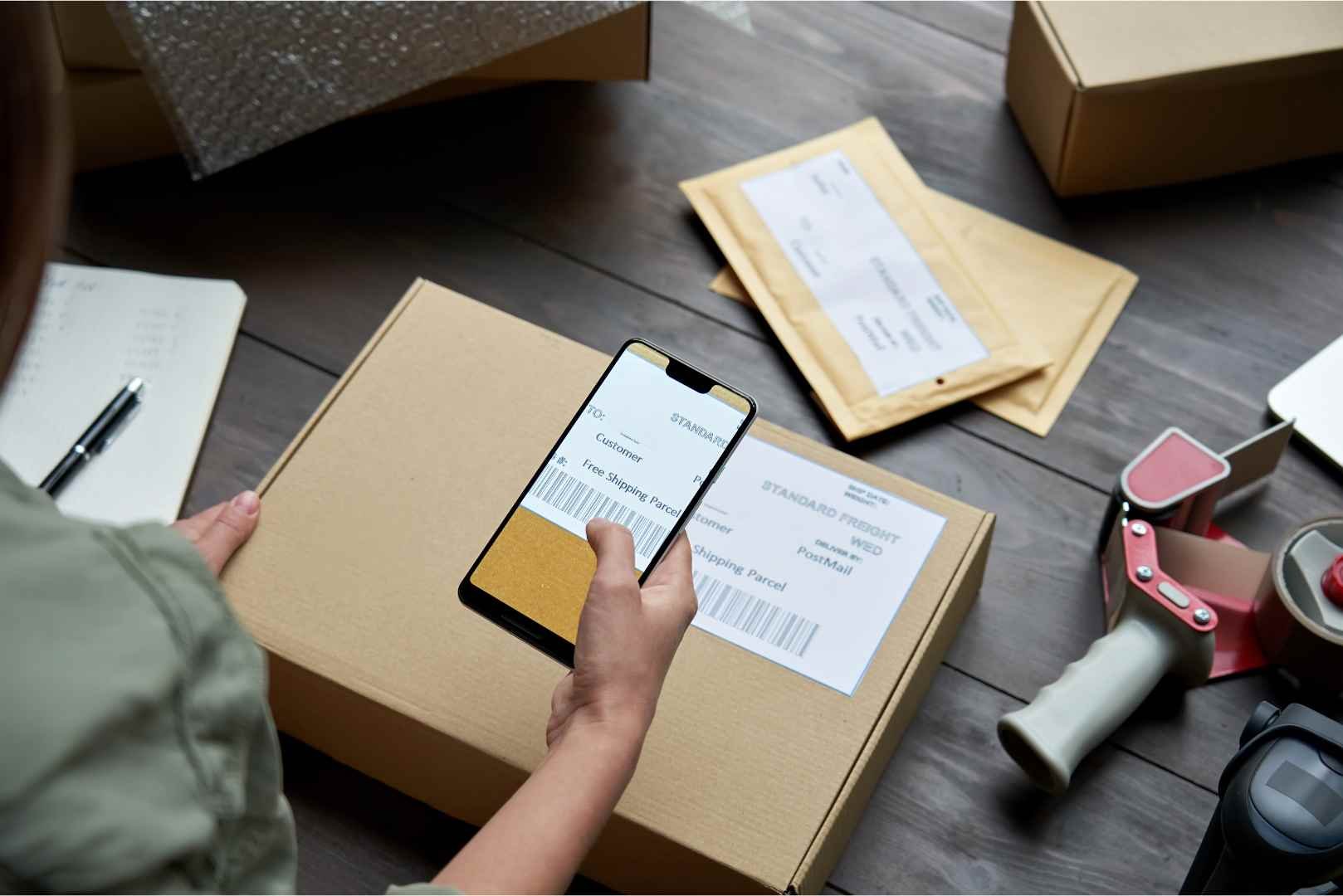 female warehouse worker dropshipping holding phone