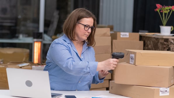 female warehouse worker scanning barcode