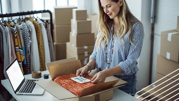 female-ecommerce-seller-packing-product-for-delivery