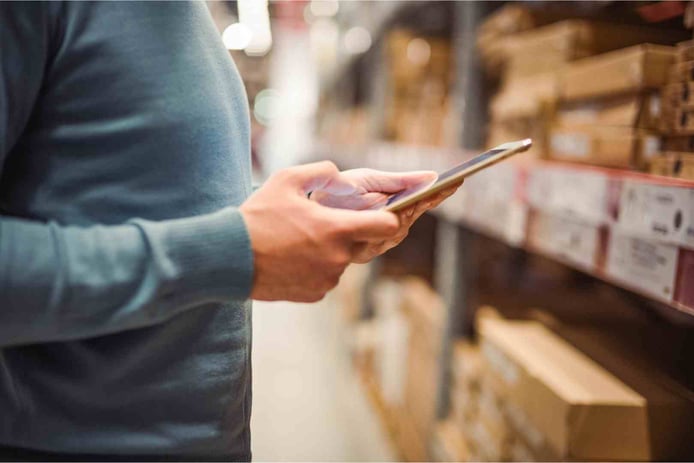 man using tablet in warehouse