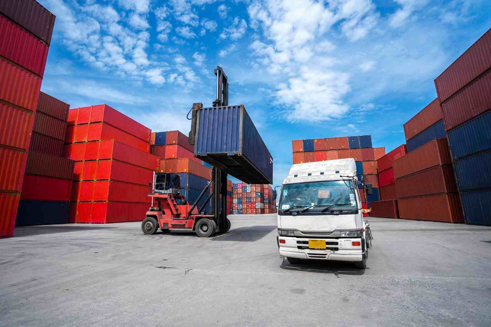 truck while loading in logistics shipping yard with forklift cargo container