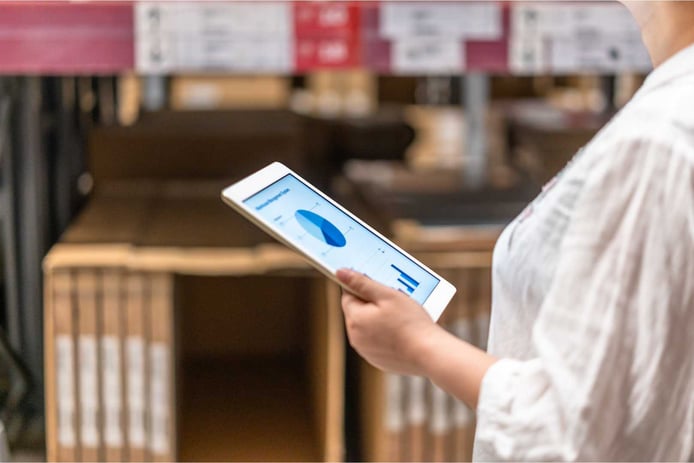 warehouse manager using a tablet to access the warehouse management system