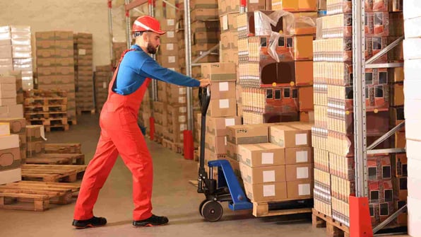 worker with pallet jack at warehouse