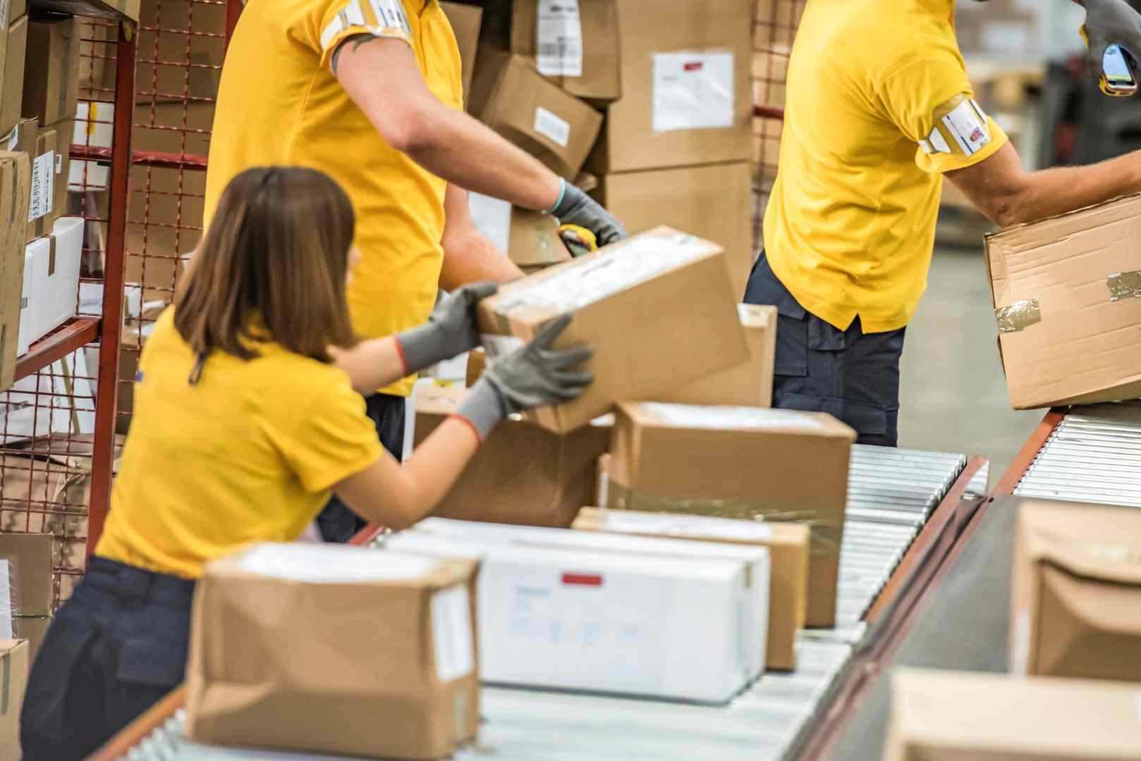 workers sorting packages in a warehouse
